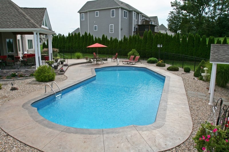 Lazy L style custom inground swimming pool by Cypress Pools