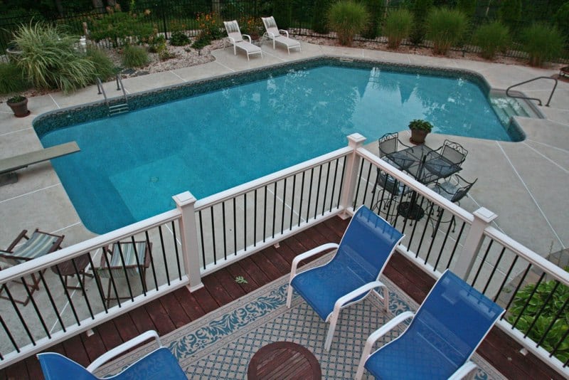 Lazy L style custom inground swimming pool overlooking from the deck by Cypress Pools