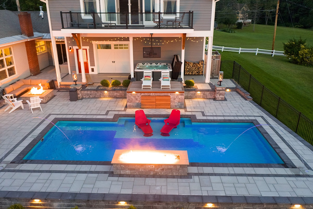 Custom Fiberglass pool with sun deck and water features located in Sacandaga, New York - built by Cypress Pools